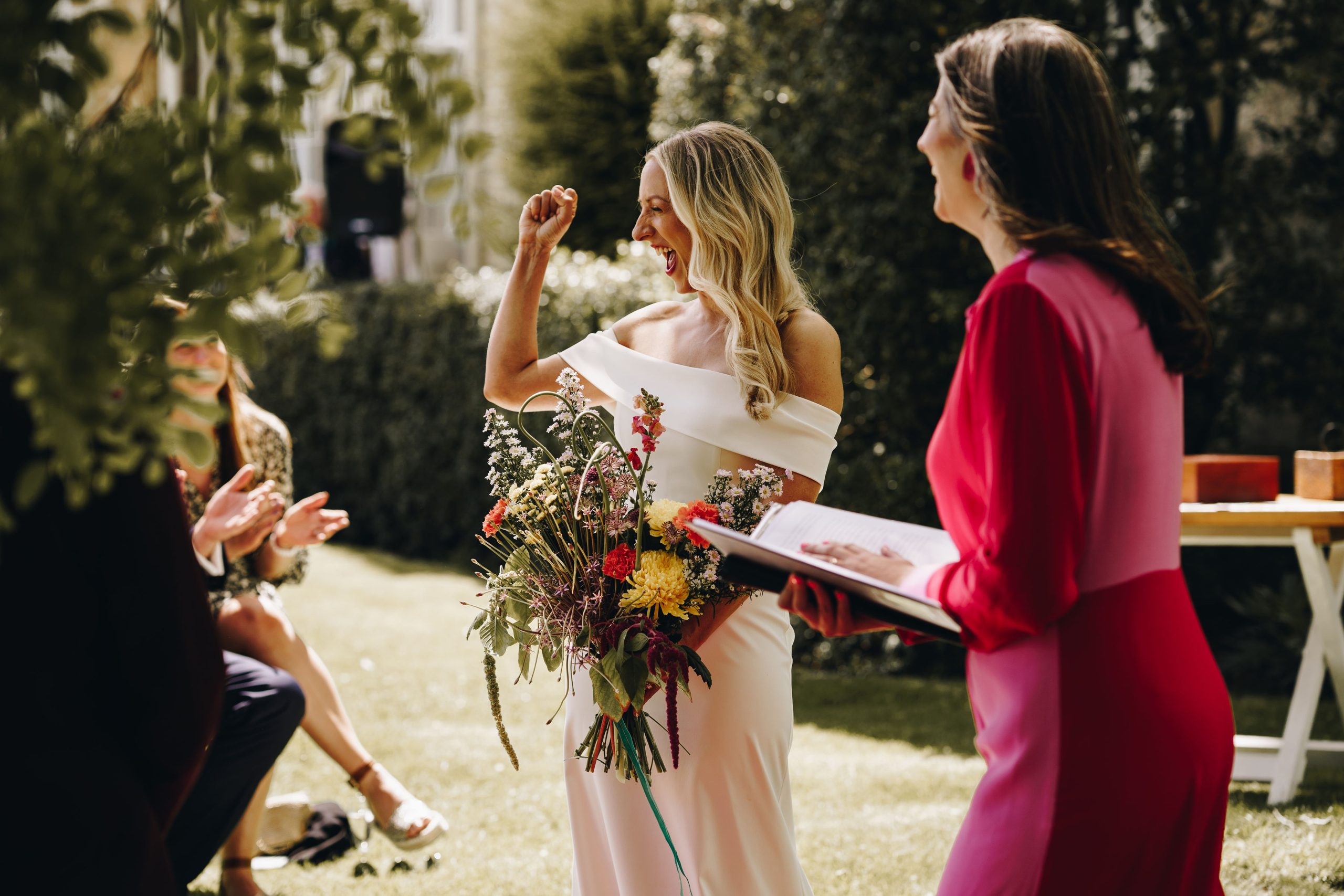 Becki at her Talton Lodge Wedding, laughing with celebrant Laura Gimson
