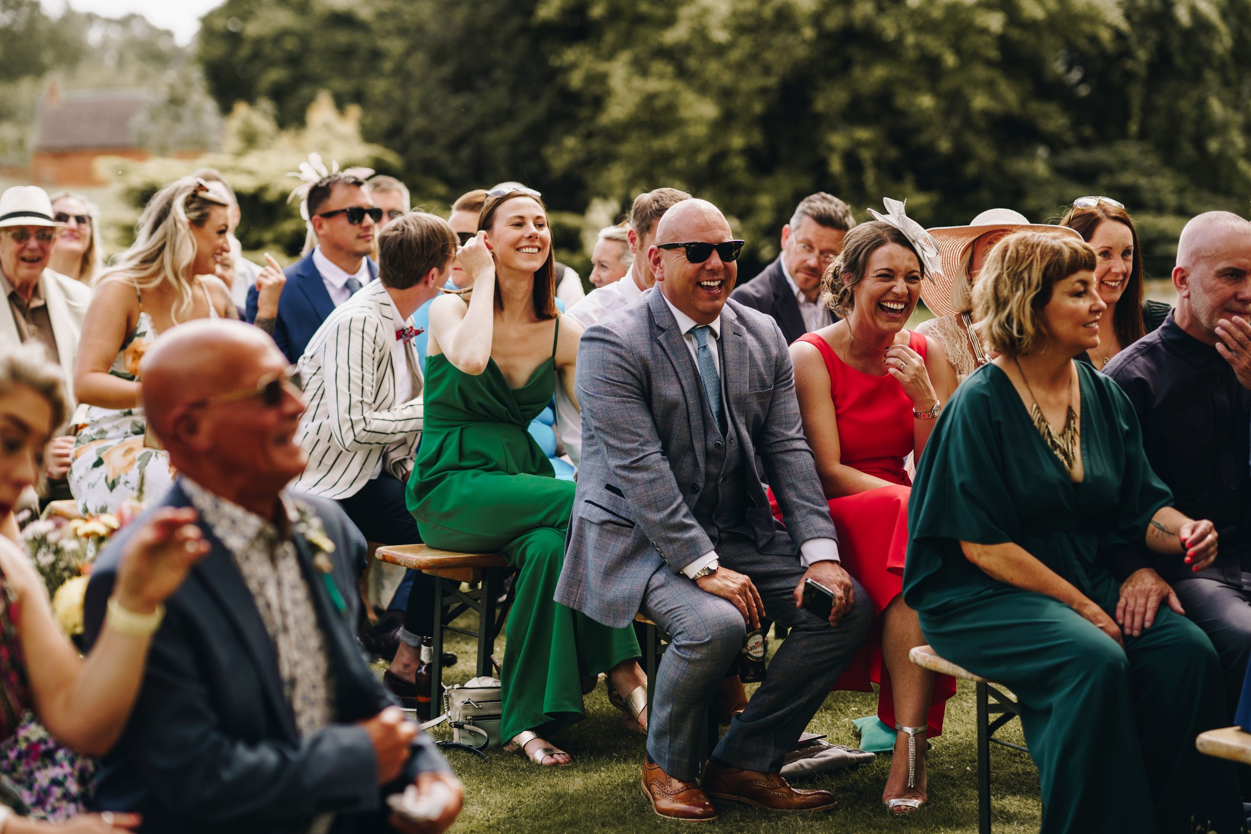 Wedding guests enjoying celebrant-led ceremony in Warwickshire countryside